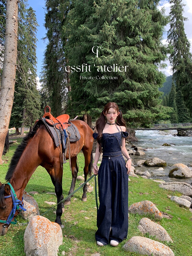 Woman wearing a dark navy outfit outdoors beside a horse