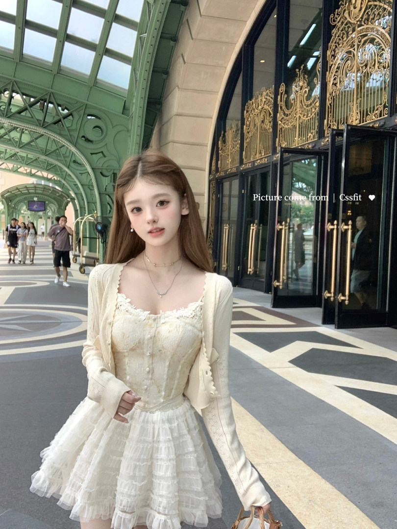 Cream lace dress with long cardigan worn by a model outdoors