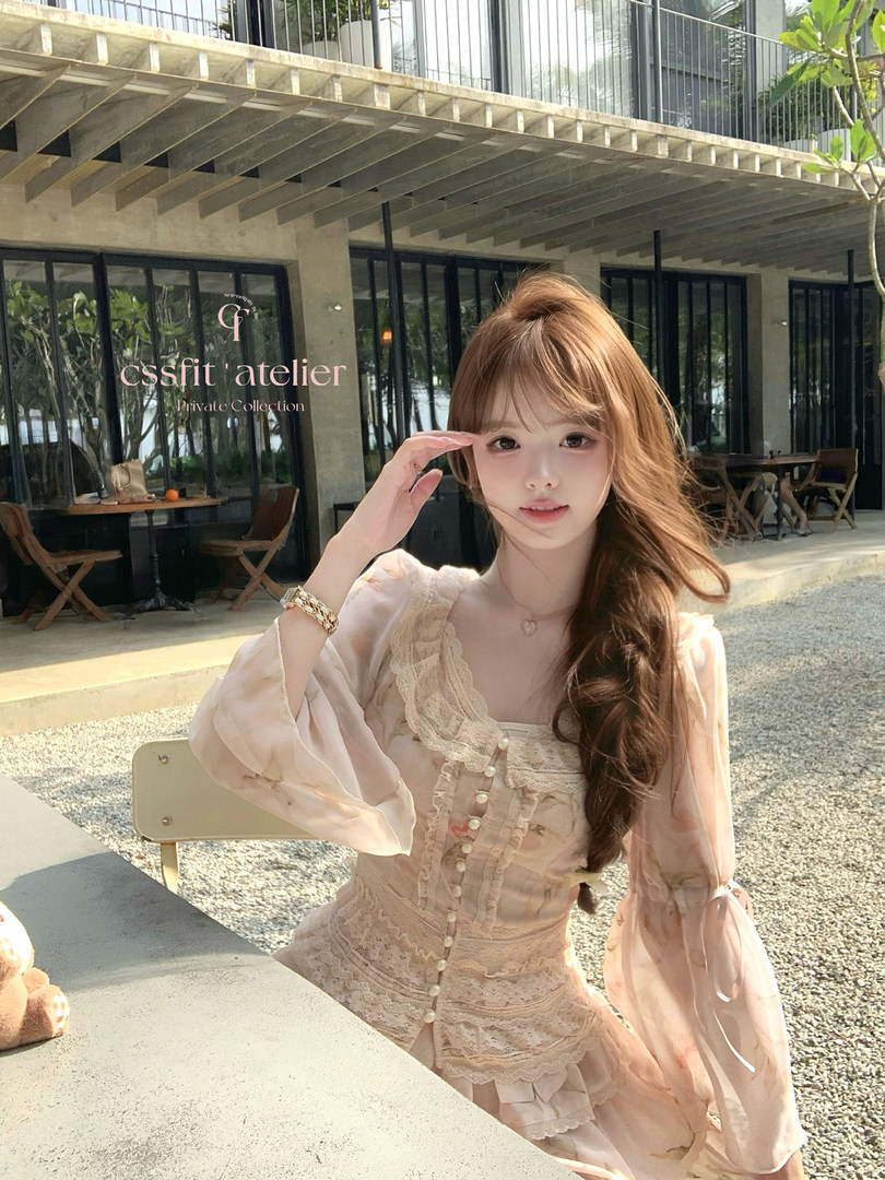 Woman wearing a light pink lace dress outdoors