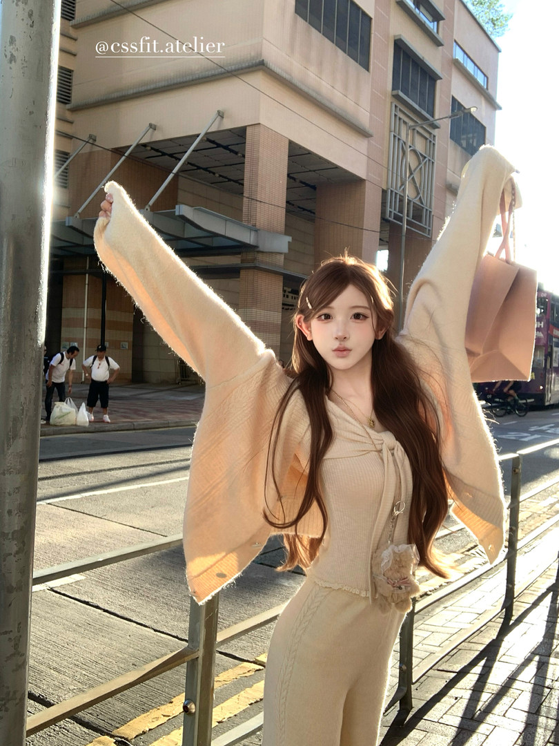 Model wearing a beige cozy knit outfit outdoors