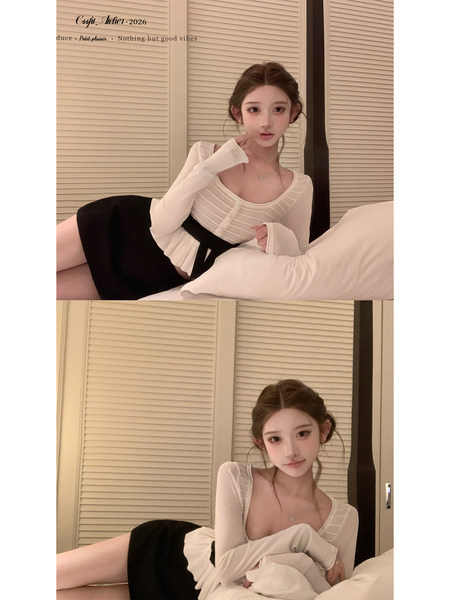 Model wearing a sheer white long-sleeve top with a black mini skirt