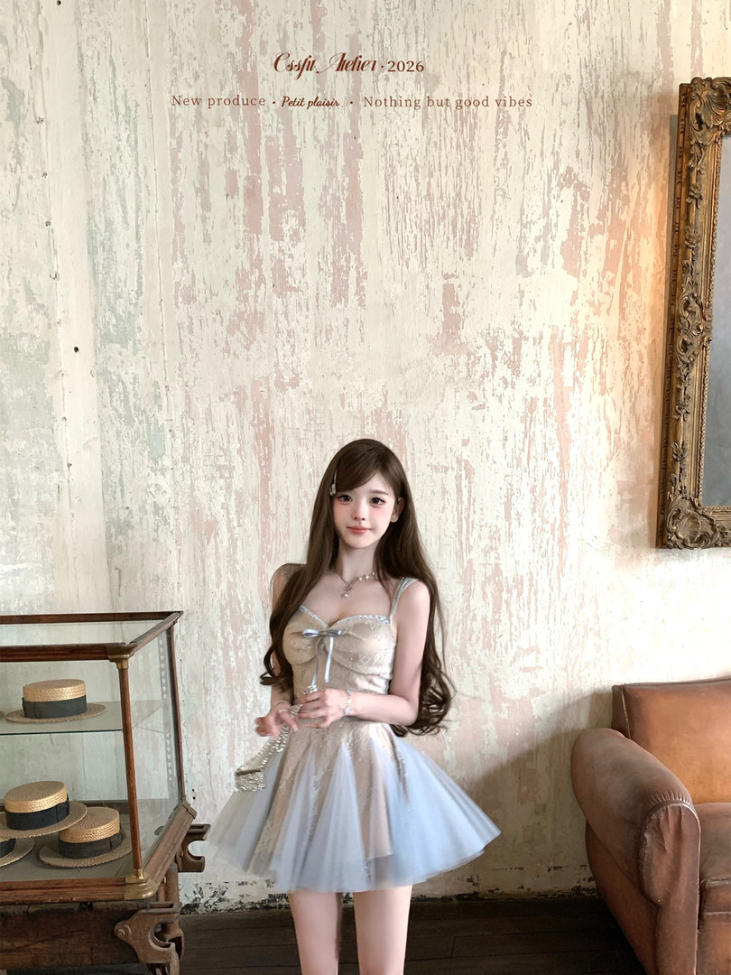 Woman wearing a light pastel dress in a boutique-style interior