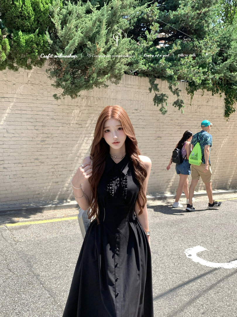 Model wearing a black sleeveless maxi dress outdoors