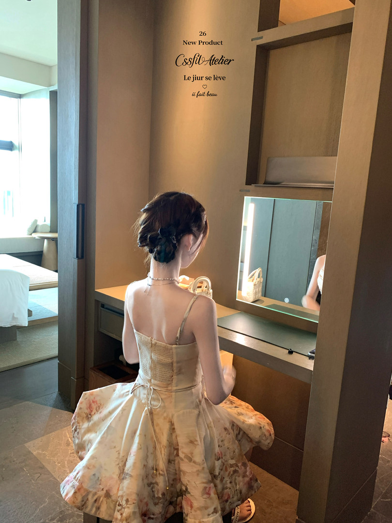 Floral sleeveless dress worn by a woman in a fitting room