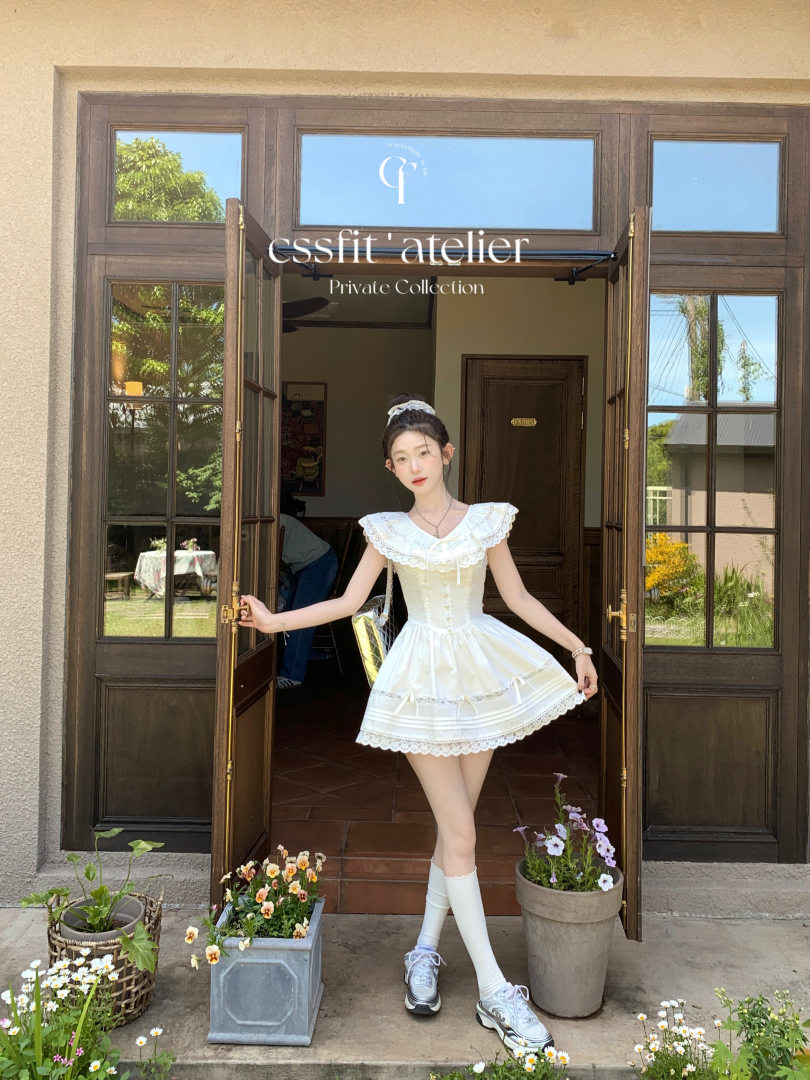 White frilly sleeveless dress worn by a model outdoors