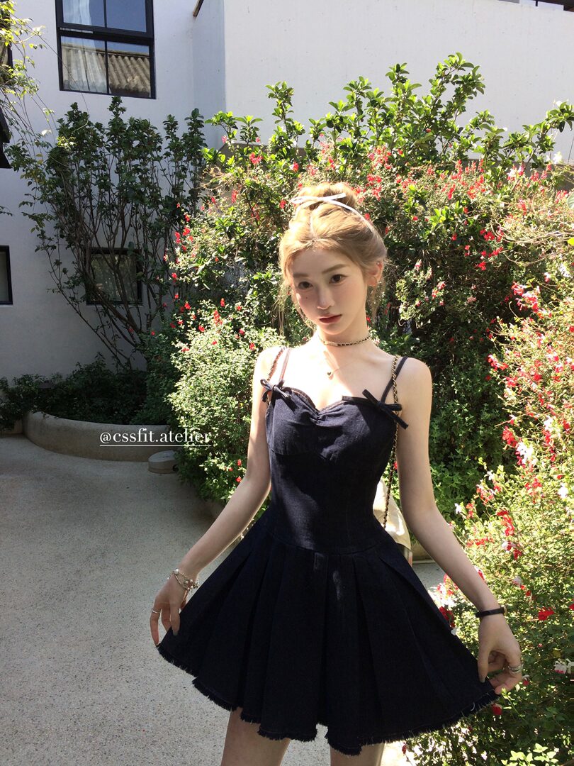 Black strappy mini dress worn by a model outdoors