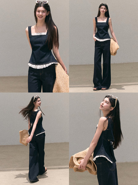 Model wearing a navy sleeveless top with white lace trim and dark wide-leg jeans