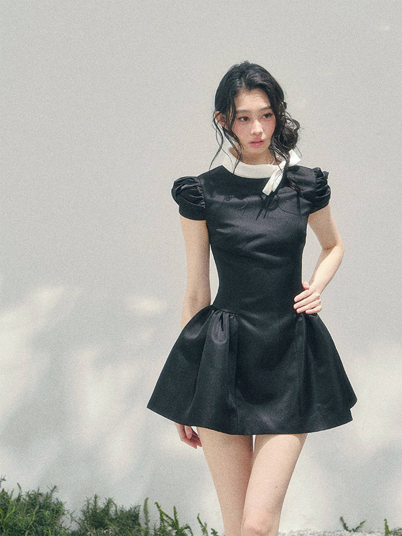 Black puff-sleeve mini dress worn by a model
