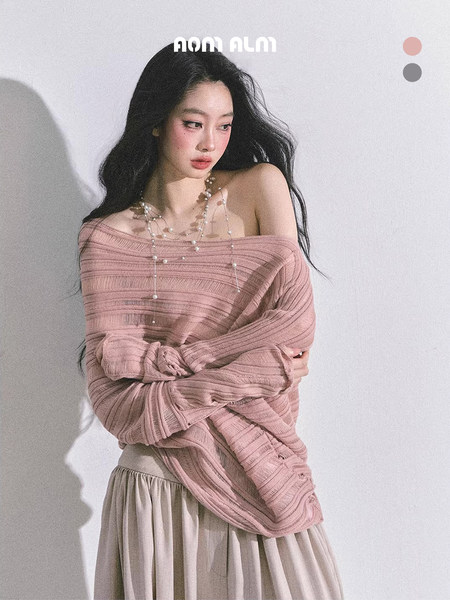 Model wearing a pink off-shoulder knit sweater and beige skirt