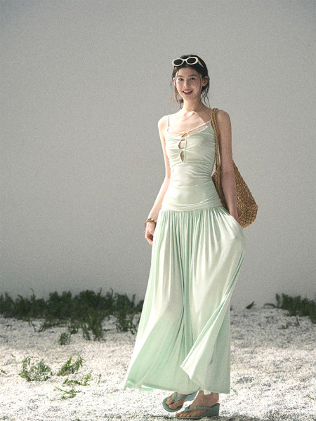 Woman wearing a light mint sleeveless maxi dress outdoors