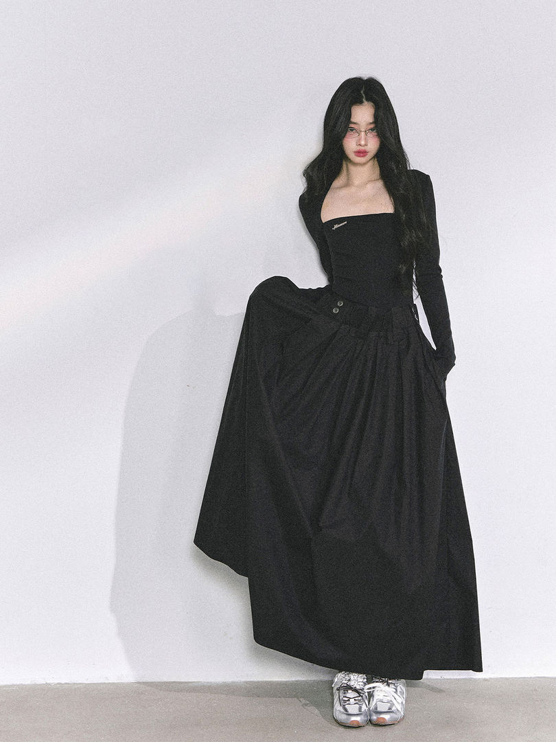Black long-sleeve maxi dress worn by a model