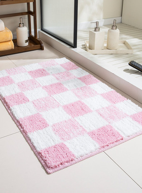 Pink checkerboard patterned bathroom floor mat with plush