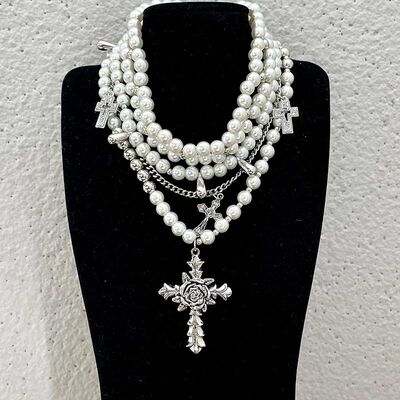 Pearl beaded necklaces are layered with men's and women's sw