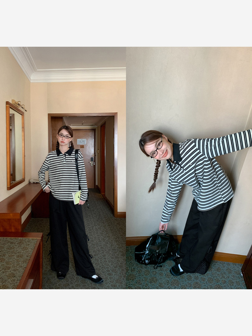 Model wearing a black-and-white striped long-sleeve polo shirt with black wide-leg pants