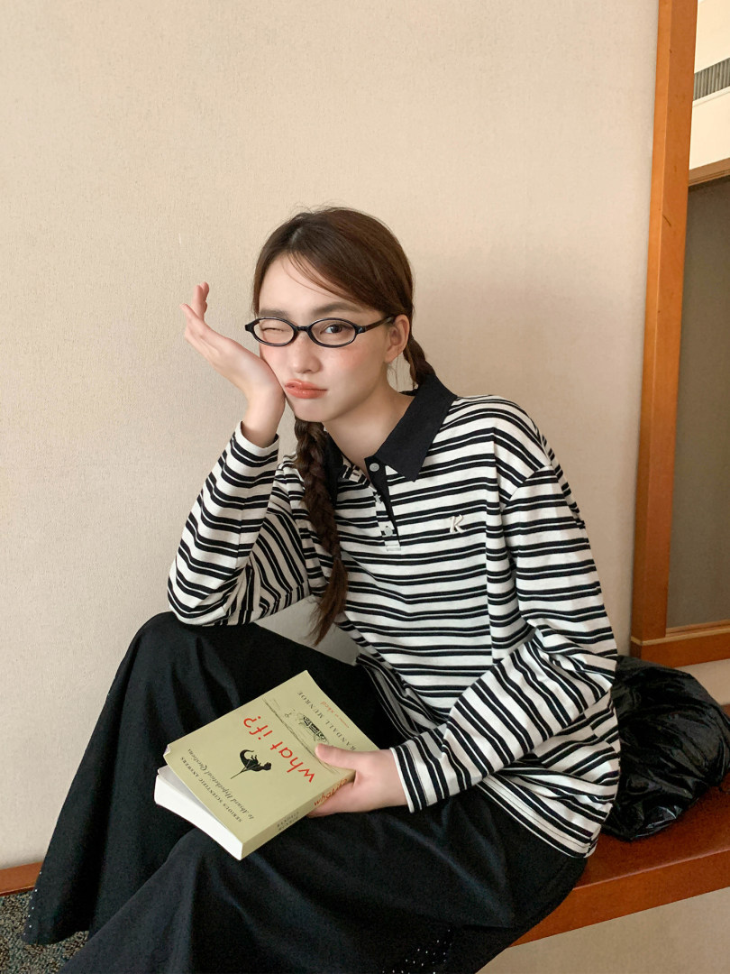 Model wearing a black-and-white striped long-sleeve collared shirt with glasses