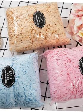 gift lined with shredded paper filling, colored packing box