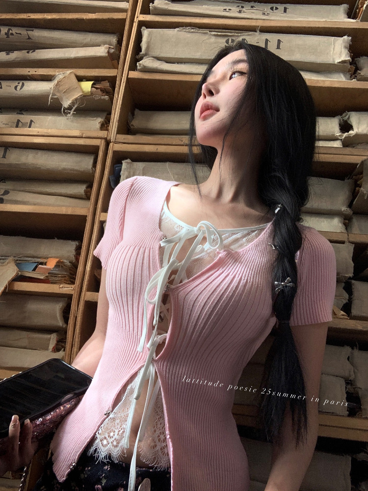 Pink ribbed lace-up knit top worn by a model