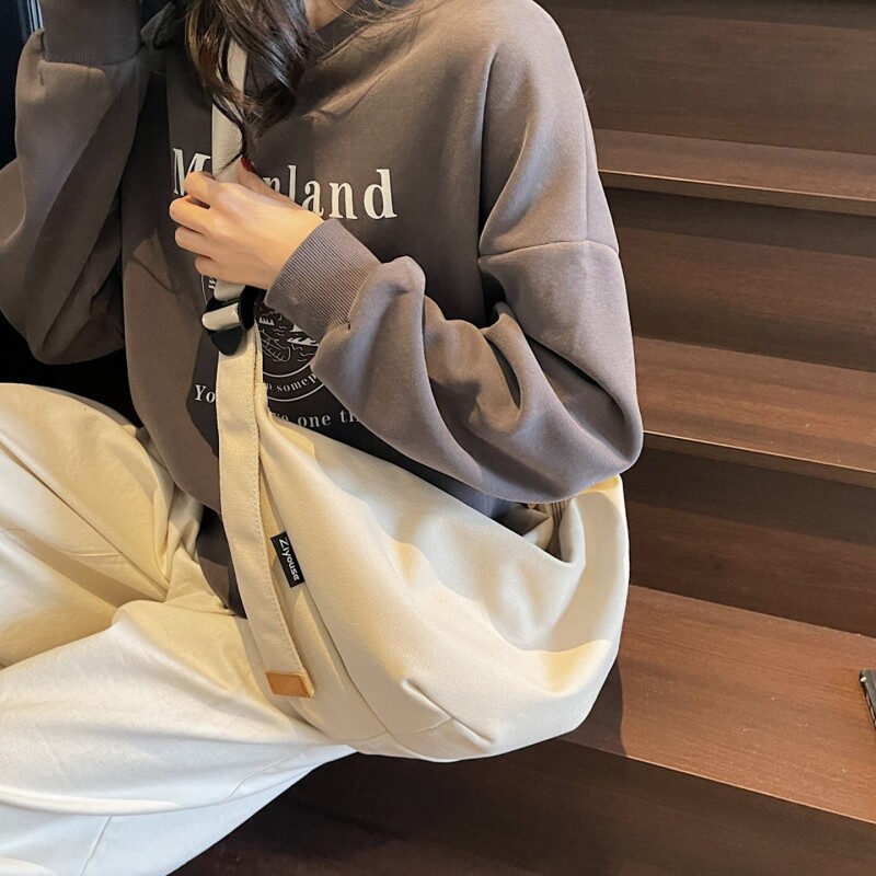 简约大容量帆布包包女2026新款春夏休闲单肩包学生通勤斜挎饺子包