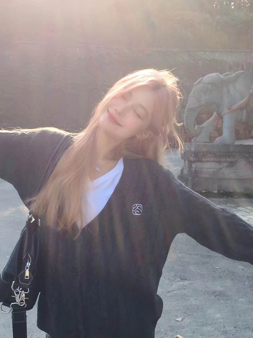 Black oversized cardigan worn over a white top