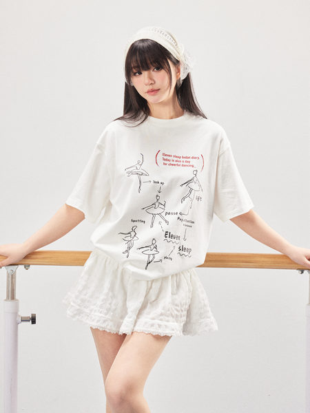 Model wearing a white graphic printed oversized T-shirt with a white skirt