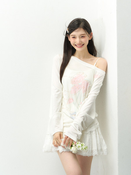 Model wearing a white off-shoulder long-sleeve top and lace-trim mini skirt