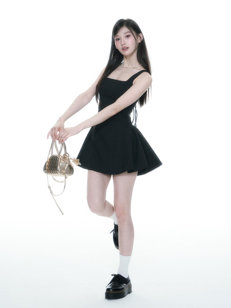 Model wearing a black sleeveless mini dress with a flared skirt