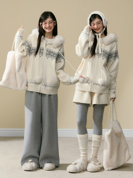 Two women modeling matching cream winter loungewear sets with gray pattern and fluffy accessories.