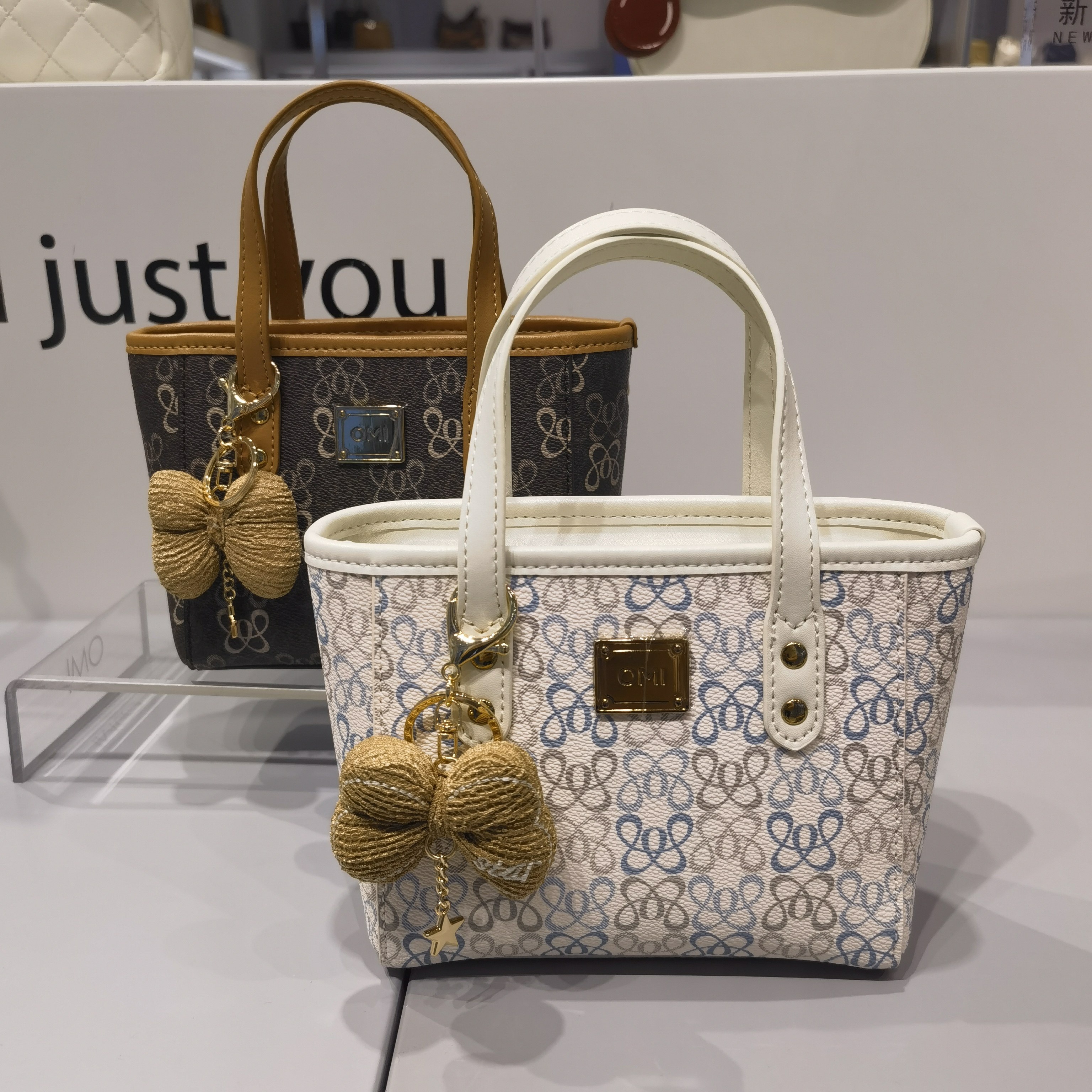 OMI欧米万达专柜新款时尚菜篮子女士手提斜挎包