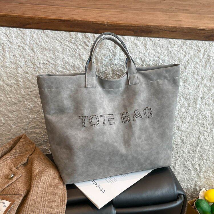 气质通勤多巴胺铆钉字母托特大包2026新款大容量手提购物袋妈咪包