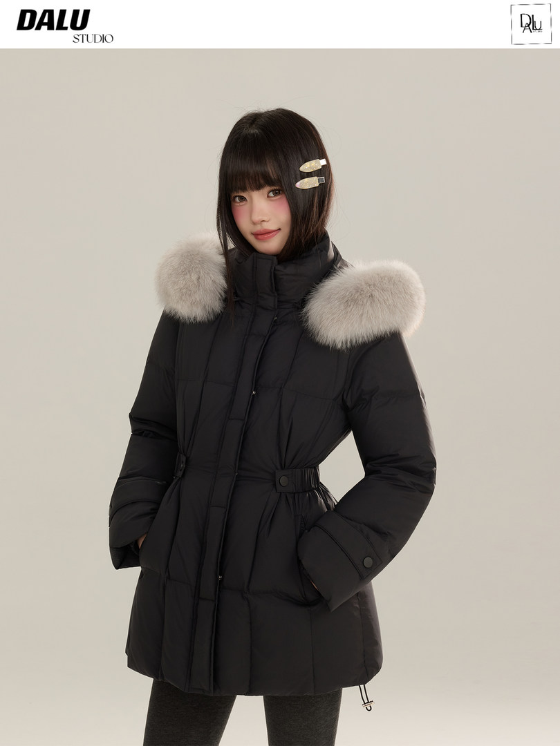 Black puffer winter coat with fur-trimmed hood worn by a model
