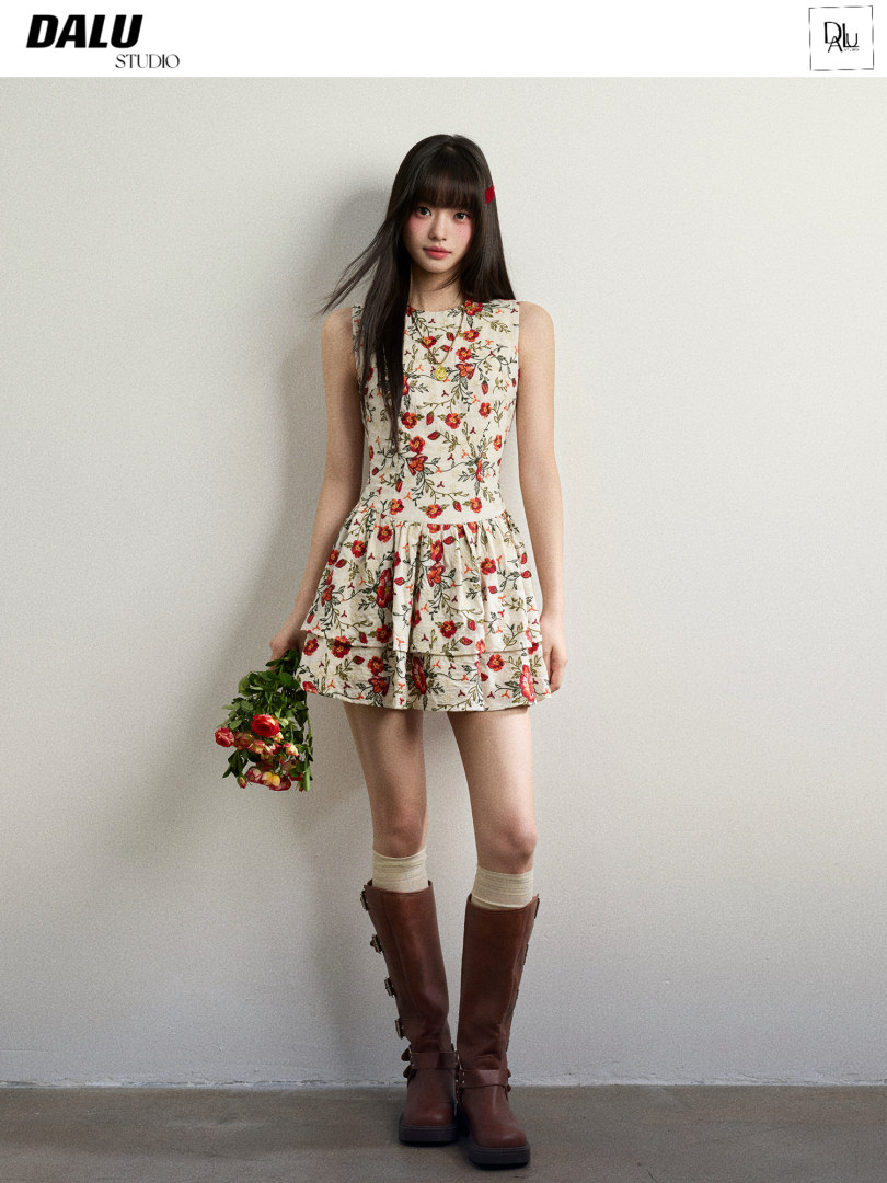 Floral sleeveless mini dress worn by a model with brown knee-high boots