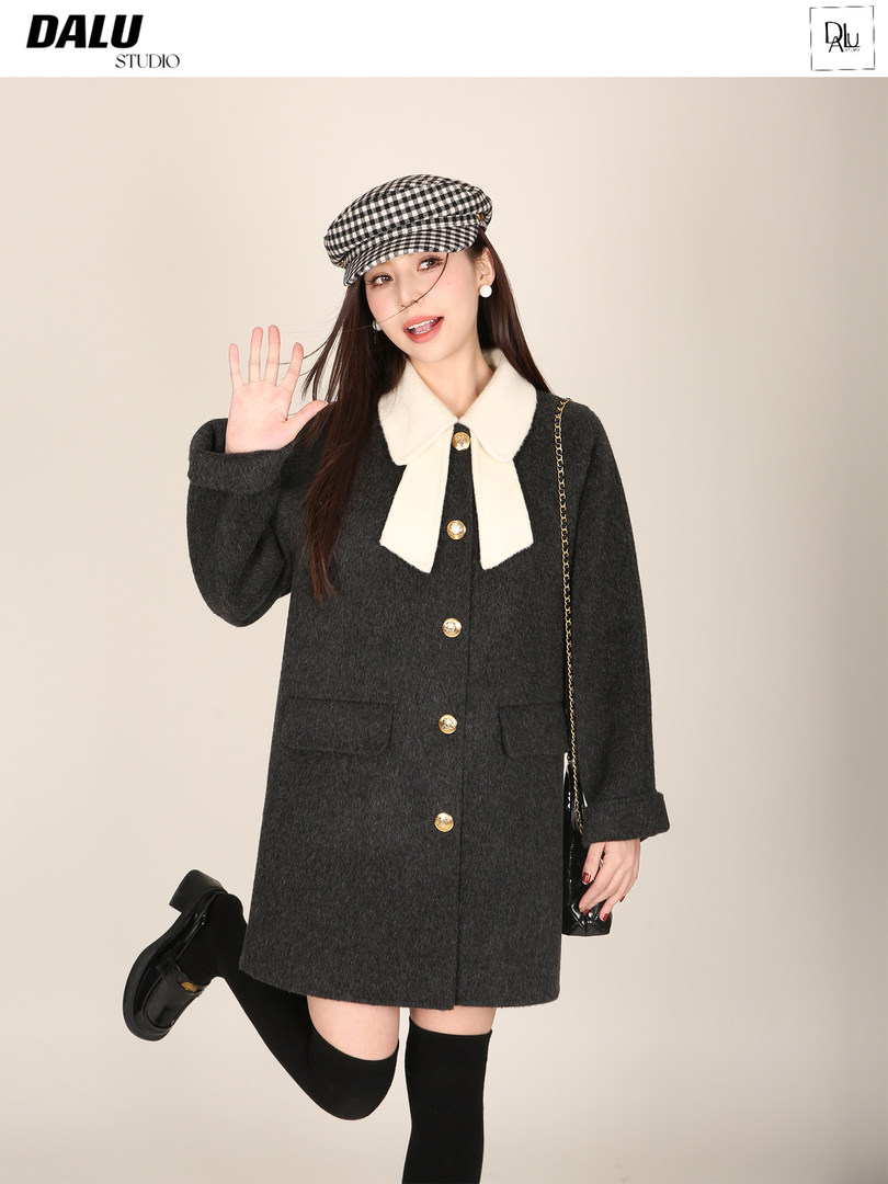 Model wearing a dark wool coat with white collar and checkered cap