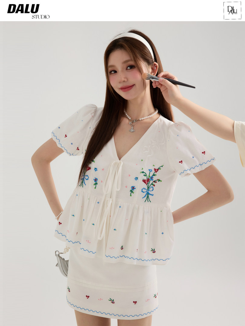Woman wearing a white floral embroidered puff-sleeve dress