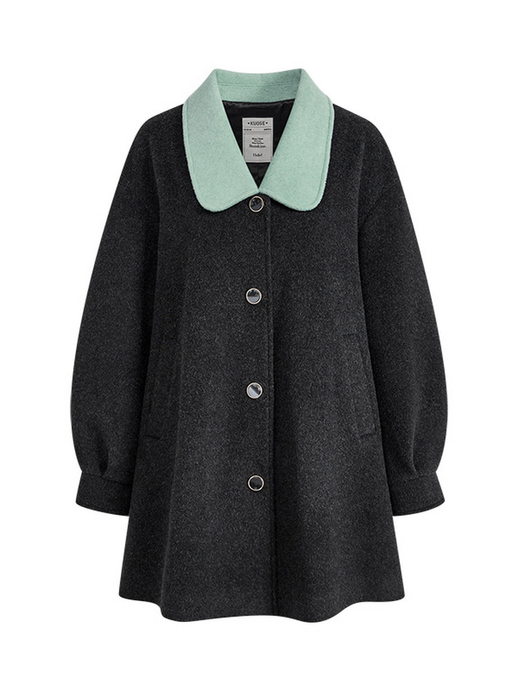 Black coat with mint green collar laid flat on a white background