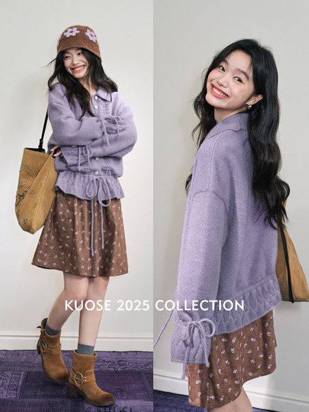 Model wearing a lavender knit cardigan and brown floral skirt with boots and a tote bag