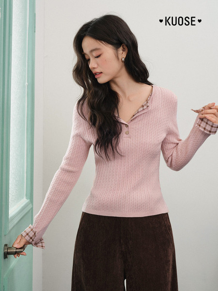Model wearing a pink ribbed long-sleeve knit top with plaid cuffs