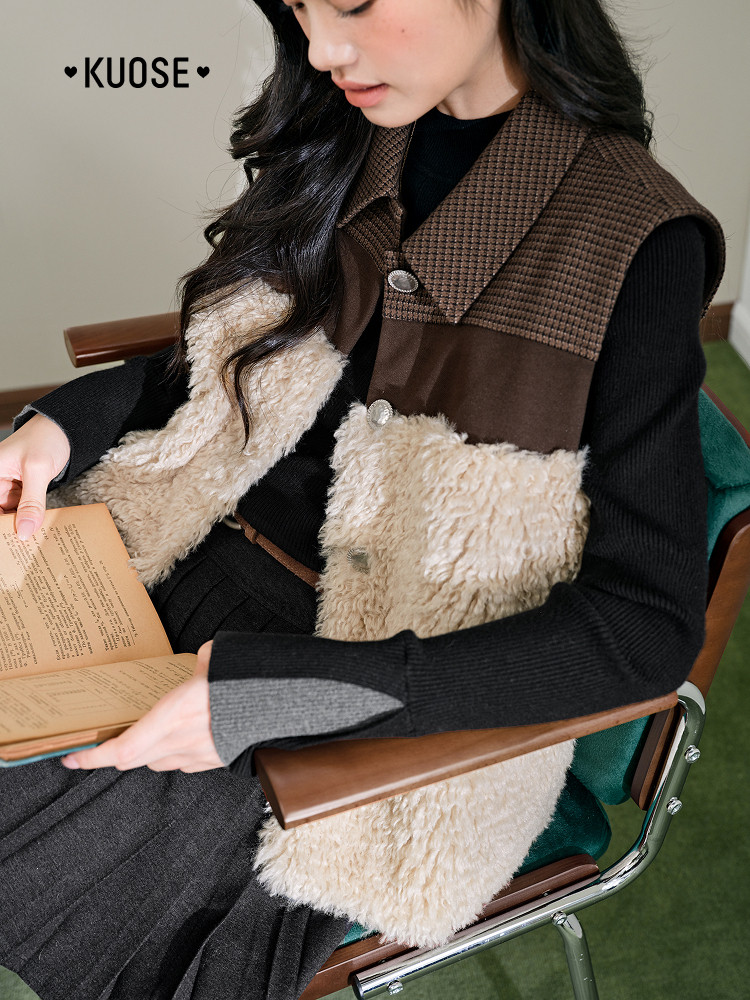 Model wearing a brown and cream shearling vest over a black outfit
