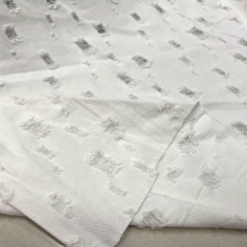 牛仔布面料 春夏外套裤子套装 纯白色斜纹色织底拉丝破洞提花布料
