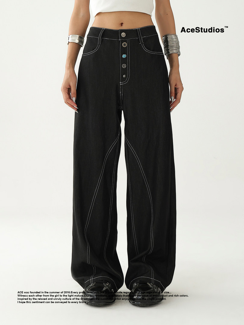 Black wide-leg jeans with contrast stitching worn on a model