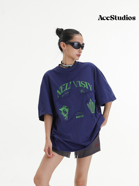 Model wearing a navy oversized graphic T-shirt with green print