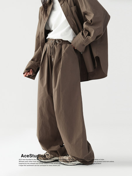 Brown oversized two-piece outfit worn by a model on a white background