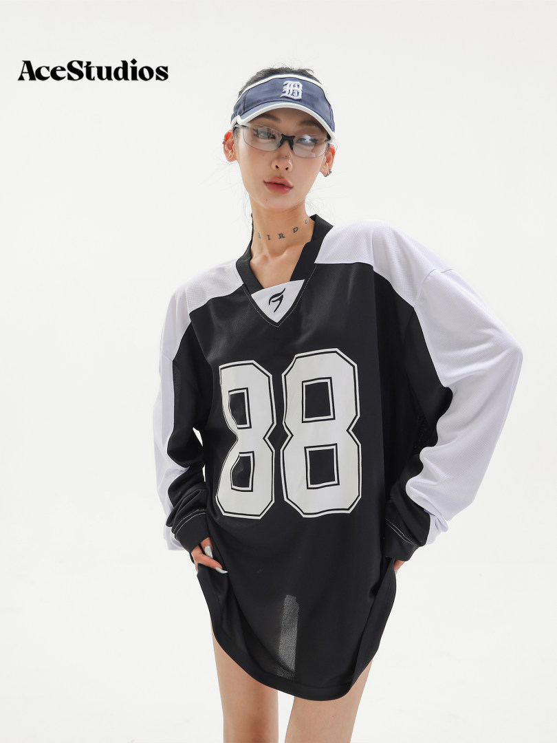 Black and white oversized sports jersey dress worn by a model