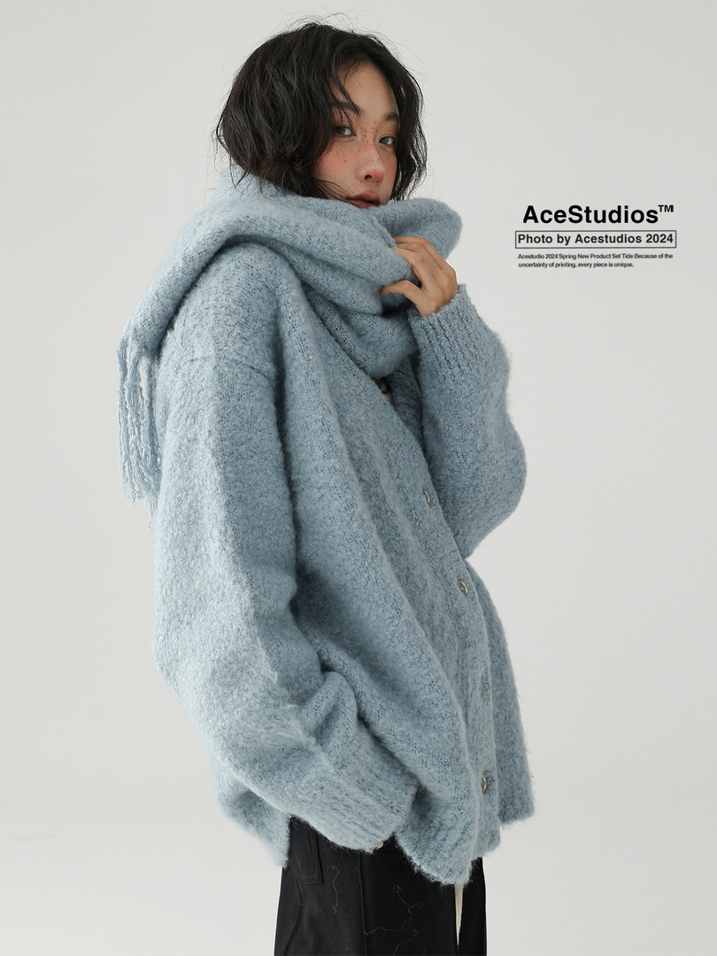 Model wearing a light blue fuzzy oversized cardigan or jacket