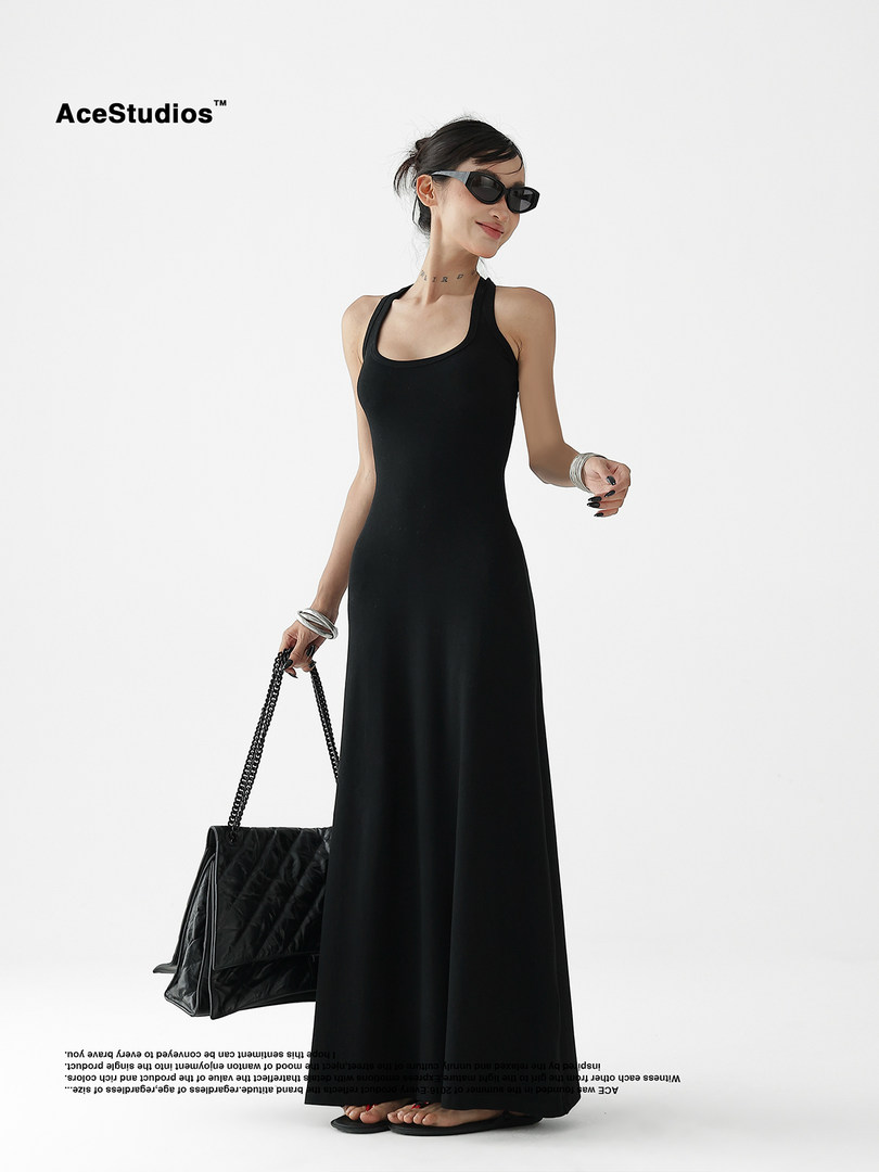 Black sleeveless maxi dress worn by a model on a white background
