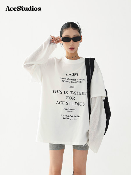 Model wearing an oversized white graphic T-shirt with black sunglasses