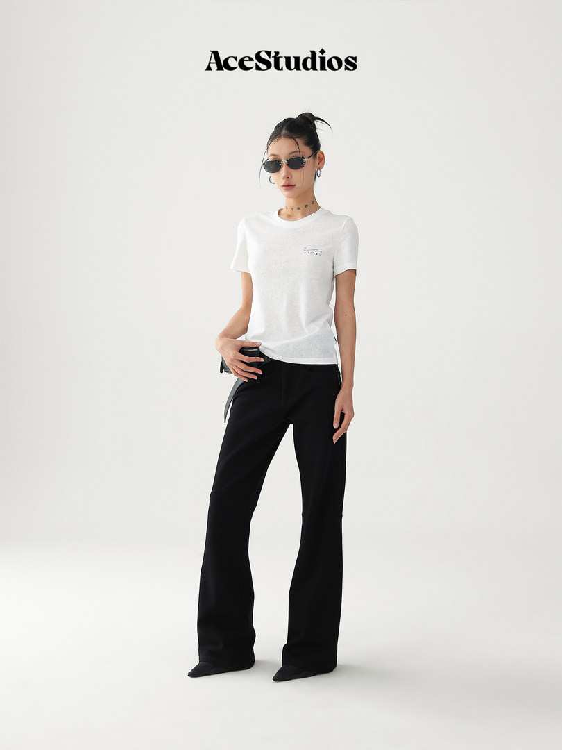 Fashion model wearing a white T-shirt and black wide-leg pants