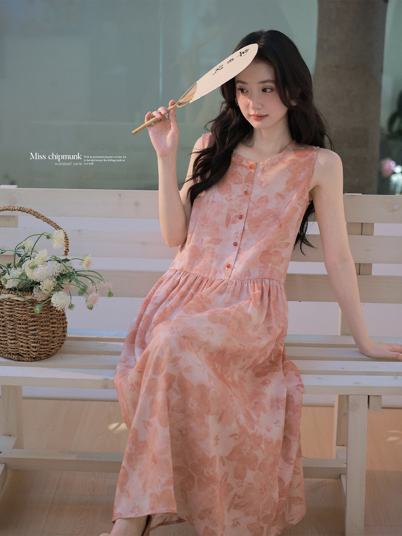 Pink floral sleeveless midi dress worn by a model