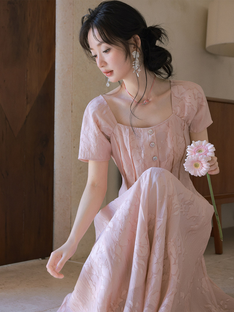 Woman wearing a pink short-sleeve floral dress