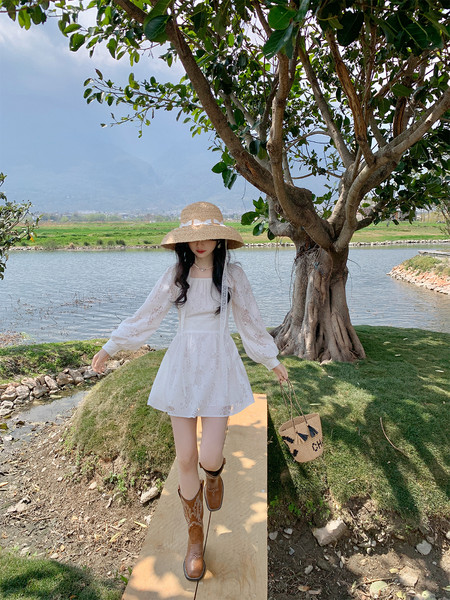 White lace long-sleeve mini dress worn outdoors with a straw hat and boots
