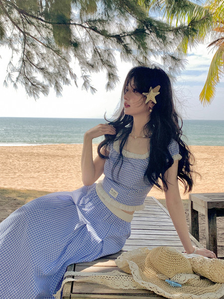 Blue gingham two-piece outfit worn by a woman at the beach